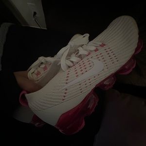 pink and white Nike running shoes